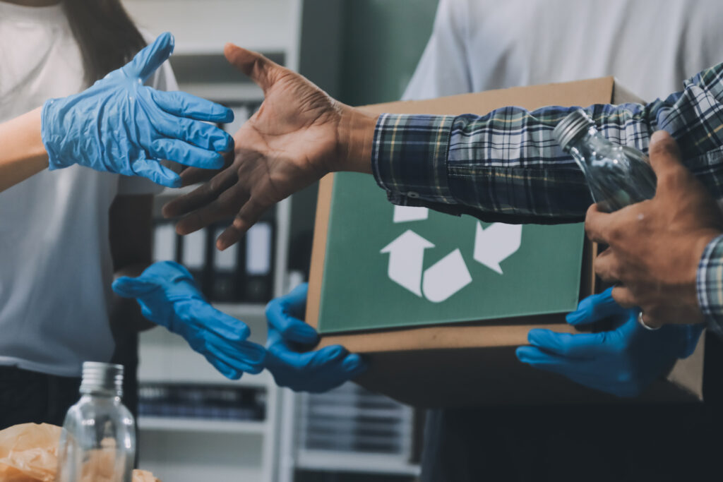 Close-up of female hands from a family collecting plastic waste